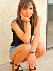 Risi in a skirt and heels flashing outdoors